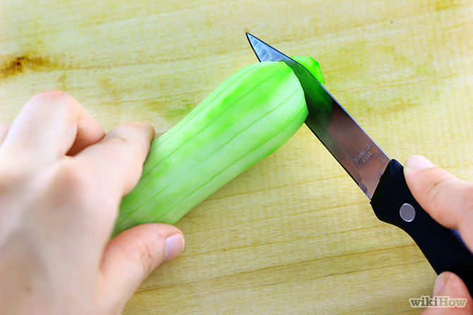 2. Slice off the ends of your cucumbers using a sharp knife. The bottom and top stem are hard, inedible parts that you should not attempt to turn into juice.