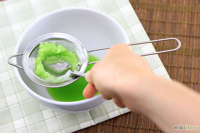 9. Stir the puree with a rubber spatula or metal spoon, occasionally pressing down into the cheesecloth or mesh. By stirring the cucumbers, you encourage the juice to seep out and flow through the strainers, into the bowl. Continue stirring and pressing until no more juice comes out.