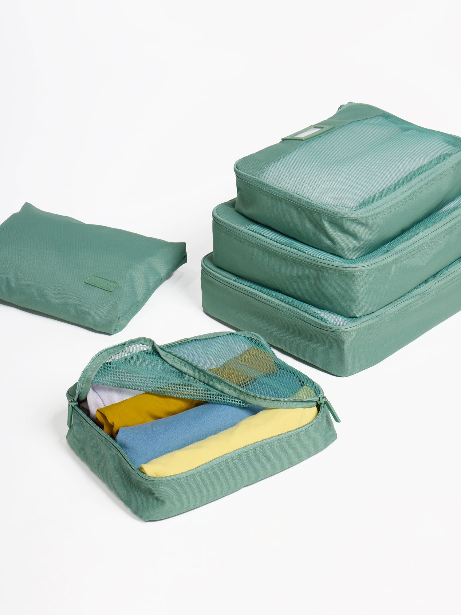 CALPAK five-piece packing cubes in green